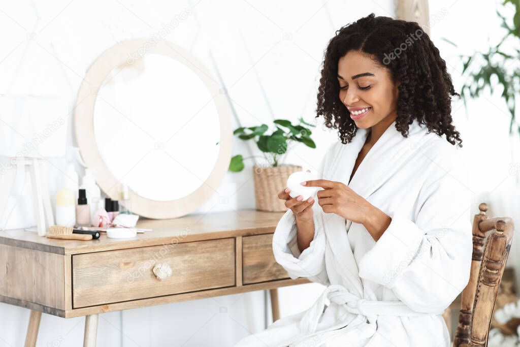 Daily Skincare. Beautiful Black Woman Using Moisturising Cream For Skin At Home