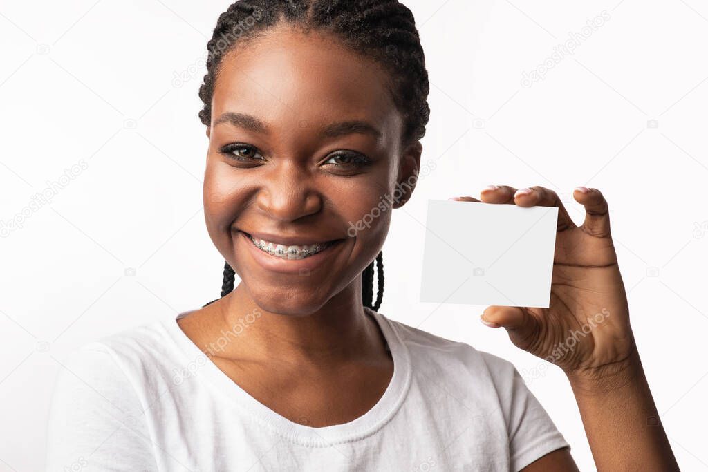 Black Woman In Braces Showing Visiting Card, White Background, Mockup