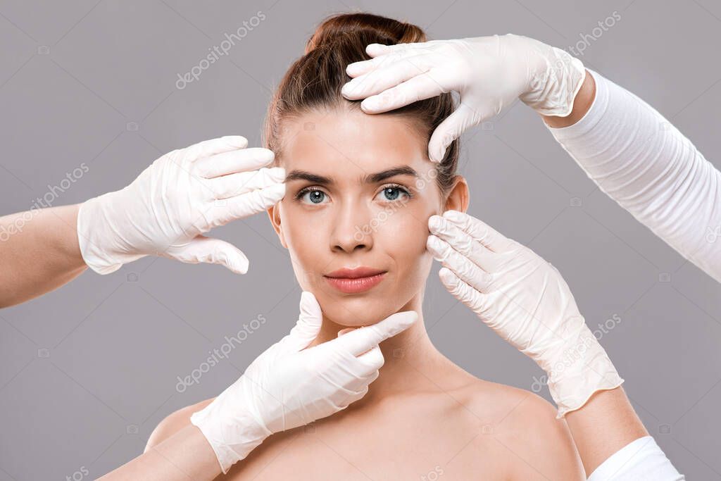 Attractive young woman getting treatment at beauty clinic