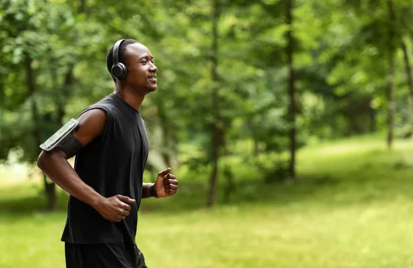 Side view of african man jogger training at park — Stock Photo, Image