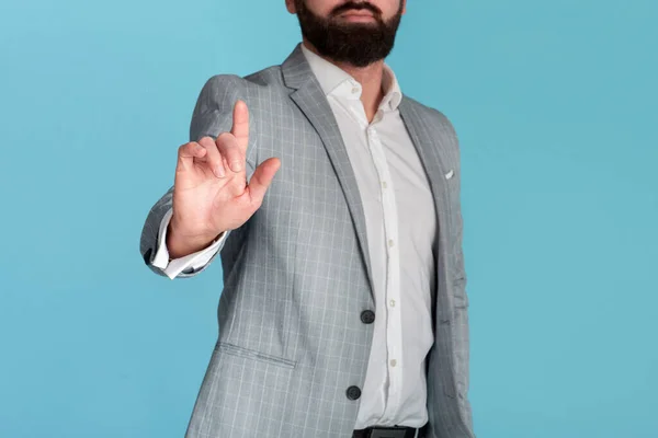 Unrecognizable businessman pushing button on virtual screen against blue background, space for design — Stock Photo, Image