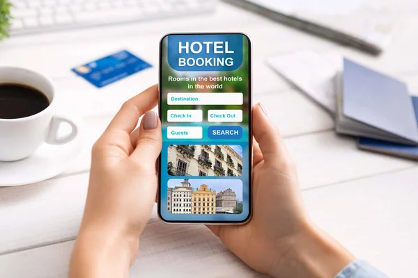 Closeup of smartphone with hotel booking app in female hands — Stock Photo, Image