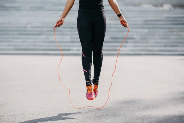 African american girl in sportswear from fitness tracker frozen in air, jumping near city stairs — Stock Photo, Image