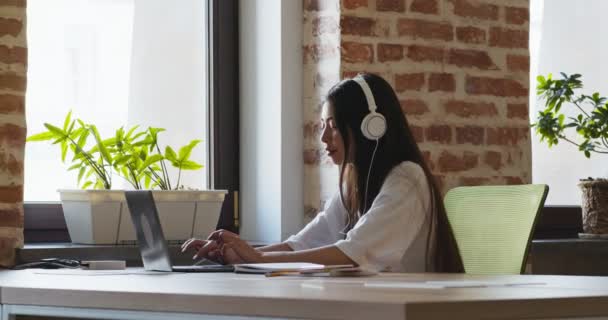 Asiática estudiante chica viendo webinar en auriculares — Vídeo de stock