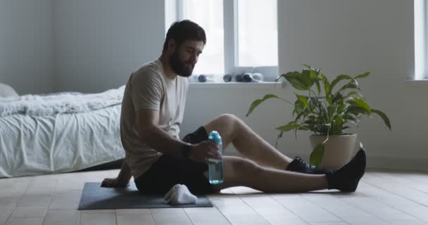 疲れた男は水を飲む、ワークアウトで休憩 — ストック動画