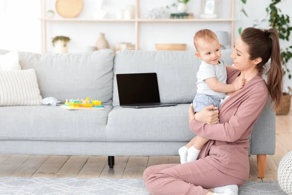 Happy Maternity Leave. Cheerful Mom Enjoying Spending Time With Baby At home