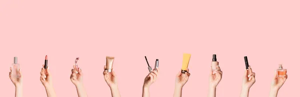 Colagem com as mãos femininas mostrando diferentes produtos de maquiagem sobre fundo rosa, espaço de cópia — Fotografia de Stock