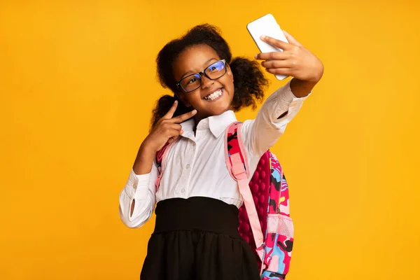 stock image Joyful Black Girl Making Selfie On Smartphone On Yellow Background