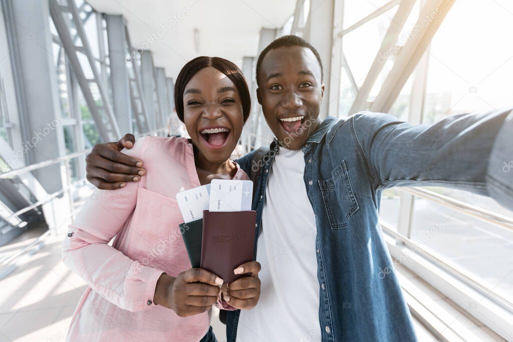 Finally Travelling. Excited African Couple Taking Selfie At Airport With Passports