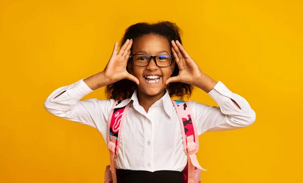 (Inggris) Joyful Schoolgirl Holding Hands Near Face Announcing Back-To-School, Studio Shot — Stok Foto
