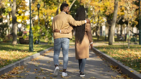 Visão traseira do casal apaixonado andando no parque de outono — Fotografia de Stock