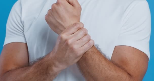 Közelkép egy férfiról, aki kéztőalagút szindrómával masszírozza a csuklóját. — Stock videók