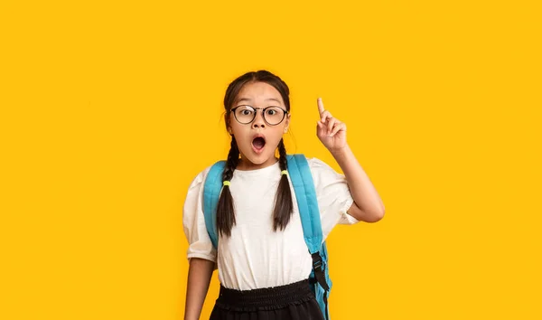 Schoolgirl Pointing Finger Up Having Idea Standing Over Yellow Background — Stock Photo, Image