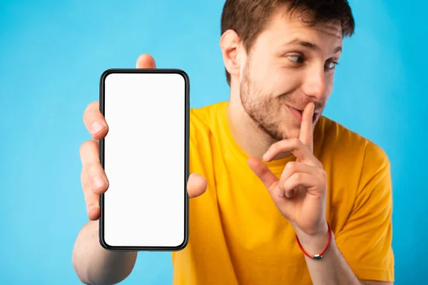 Uomo felice che mostra lo schermo del cellulare vuoto alla fotocamera — Foto Stock