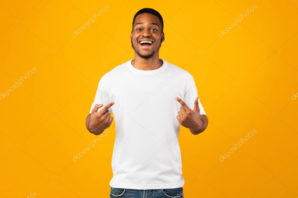 Handsome Black Guy Pointing At Himself Posing On Yellow Background