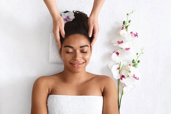 Visão superior da mulher negra alegre recebendo massagem na cabeça — Fotografia de Stock