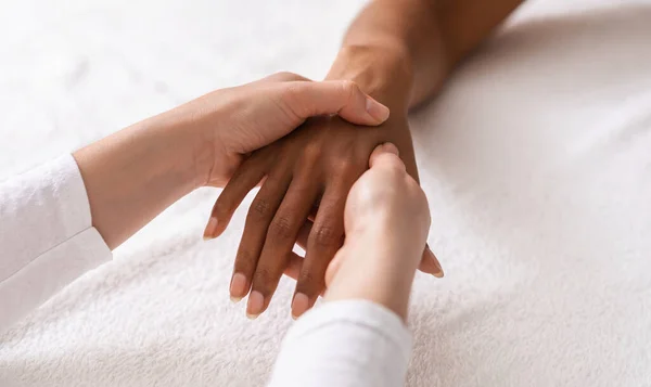 Massagista fazendo acupuntura massagem de mão para mulher negra — Fotografia de Stock