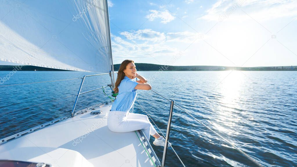 Relaxed Woman Sitting On Yacht Having Sailboat Ride In Sea