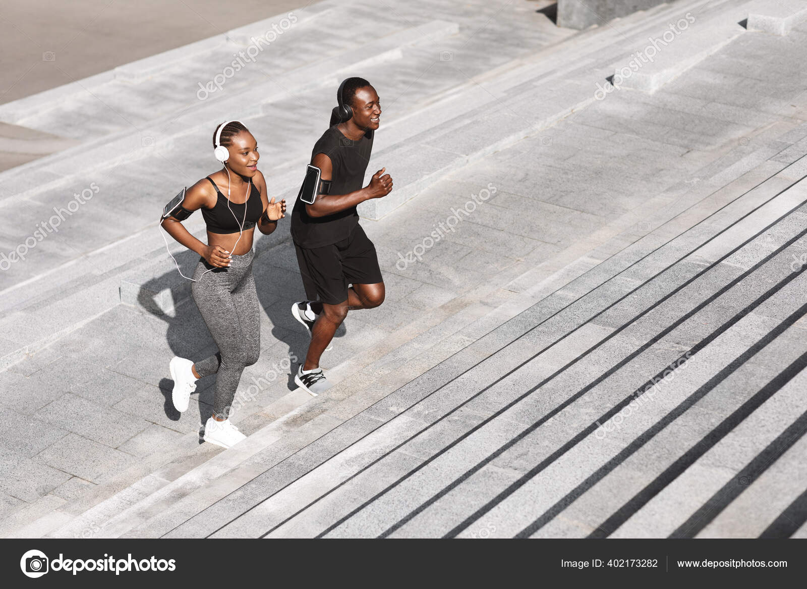 Jogging couple. African american persons man and woman running