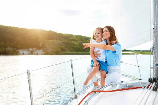 Mãe feliz e filha no convés do iate desfrutando passeio de barco — Fotografia de Stock