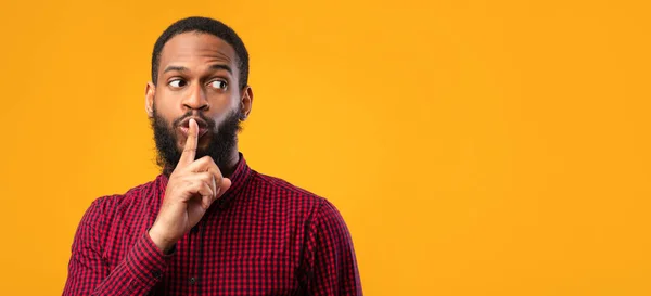 Hombre negro divertido haciendo gesto de silencio con la mano — Foto de Stock