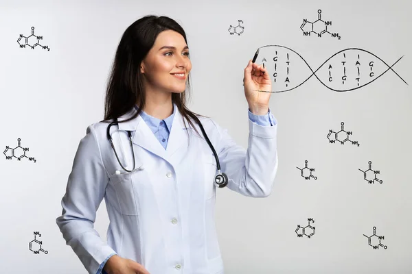 Innovative medicine and genetics. Female doctor drawing DNA spiral on invisible screen, grey background. Collage — Stock Photo, Image