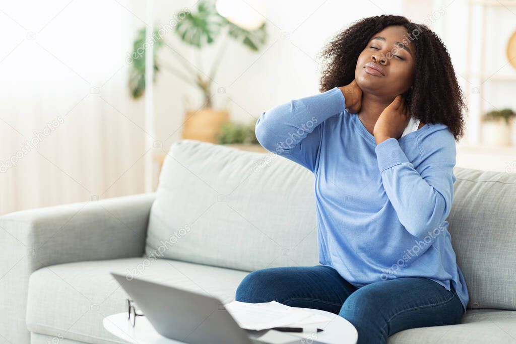 Businesswoman with neck pain after long hours at work