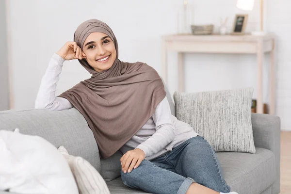Kerendahan hati modern. Beautiful Arabic Girl In Hijab Relaxing On Couch At Home — Stok Foto