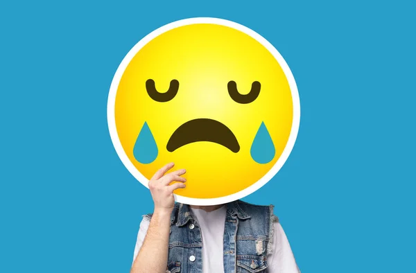 Nepoznatelný muž skrývá svou tvář za pláčem smutný emotikon emoji — Stock fotografie