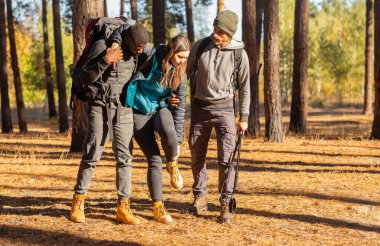 Çok ırklı adamlar, kadın arkadaşlarını yaralı bilekliklerle destekliyor.
