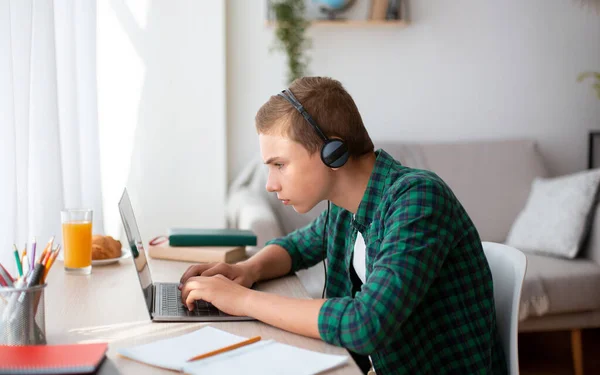 Concentrado chico nerd tener lección en línea, estudiar desde casa — Foto de Stock