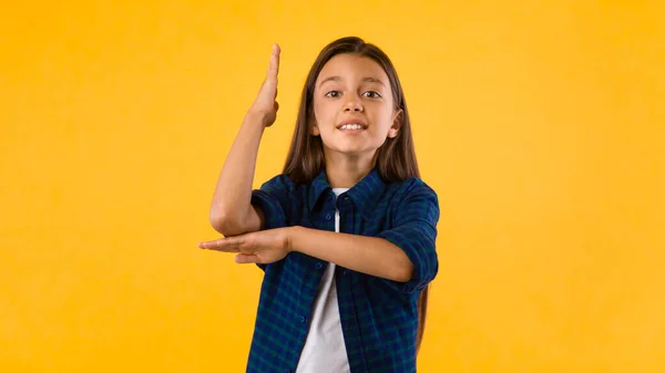 Adolescente menina levantando a mão no estúdio — Fotografia de Stock