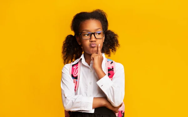 Pensive Black School Girl Thinking Posing In Studio, Yellow Background — Stock Photo, Image