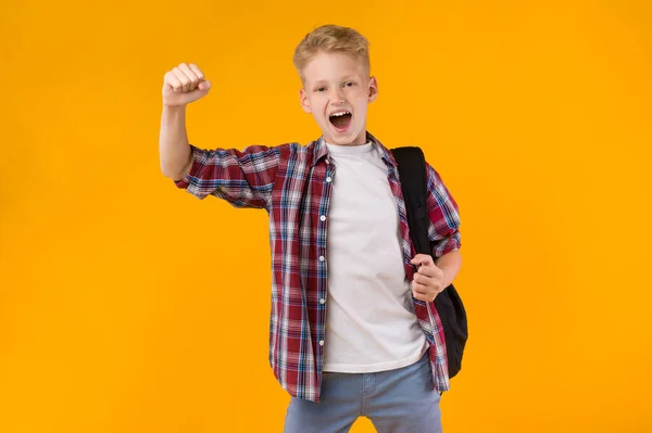 Little guy celebrating over yellow studio background — Stock Photo, Image