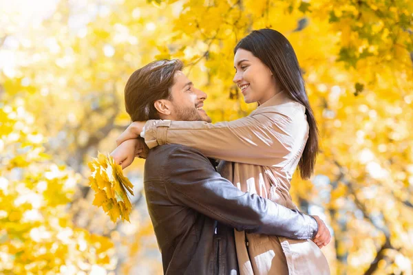 Joyful homem e mulher abraçando no parque dourado — Fotografia de Stock