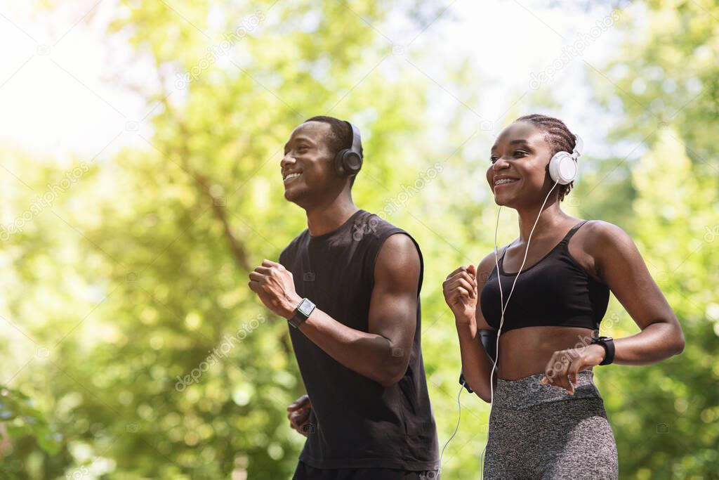 Enjoying Run. Joyful African American Couple Jogging In Summer Park