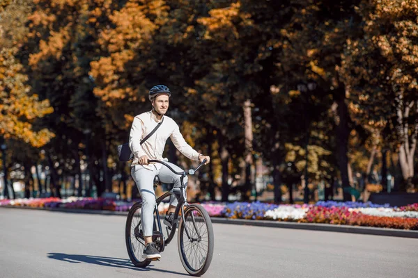 Městská ekologická doprava. Hezký hipster v helmě těší kolo — Stock fotografie