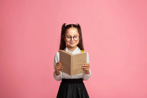 Életstílus és szabadidő. Boldog iskolás lány szemüveggel könyvet olvas. — Stock Fotó