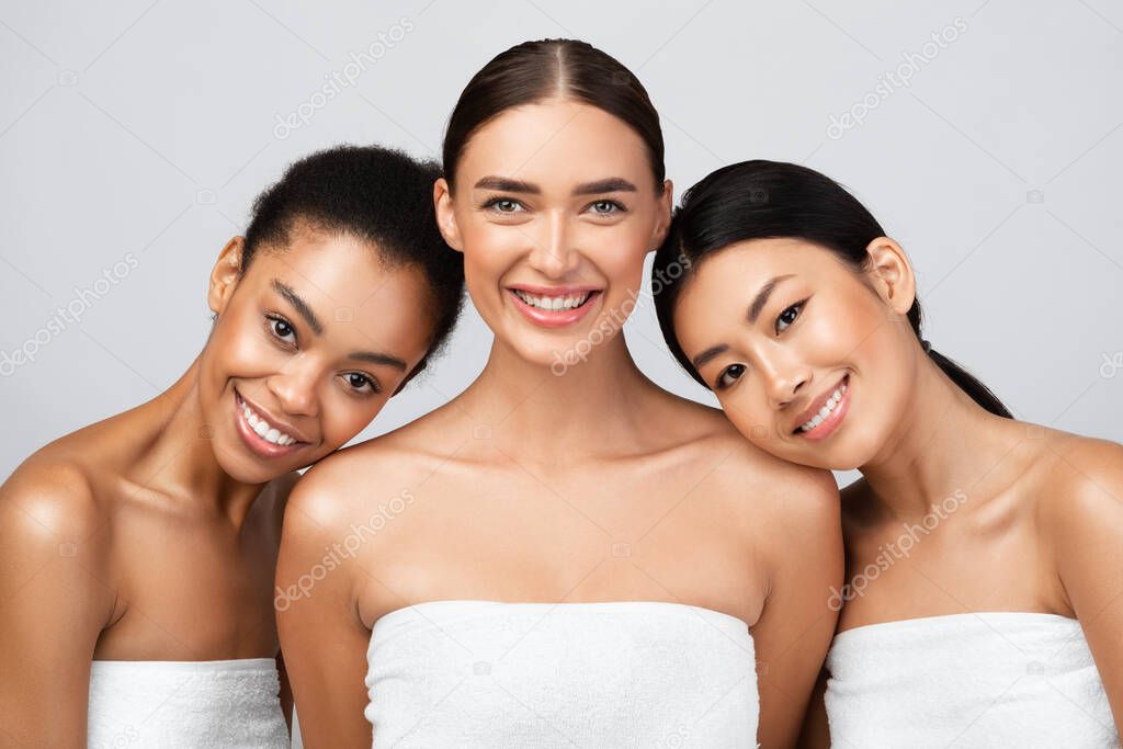 Girls Wrapped In Towels Standing On Gray Background After Shower