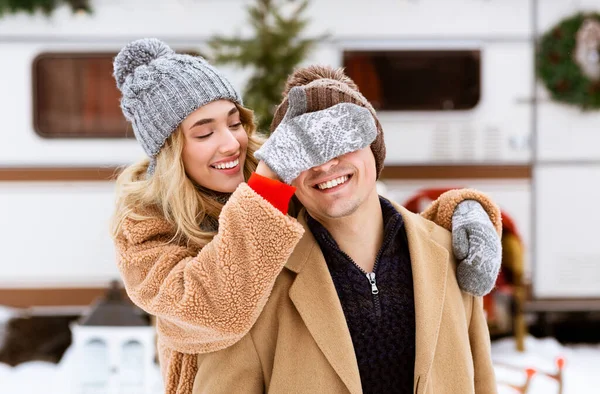 Romantisch blond mädchen covering augen von sie boyfriend während winter datum draußen — Stockfoto
