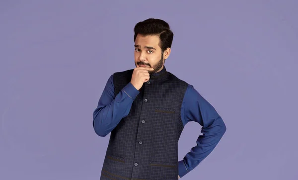 Pensive Indian Kerl Blick in die Kamera und denken über fliederfarbenen Hintergrund — Stockfoto