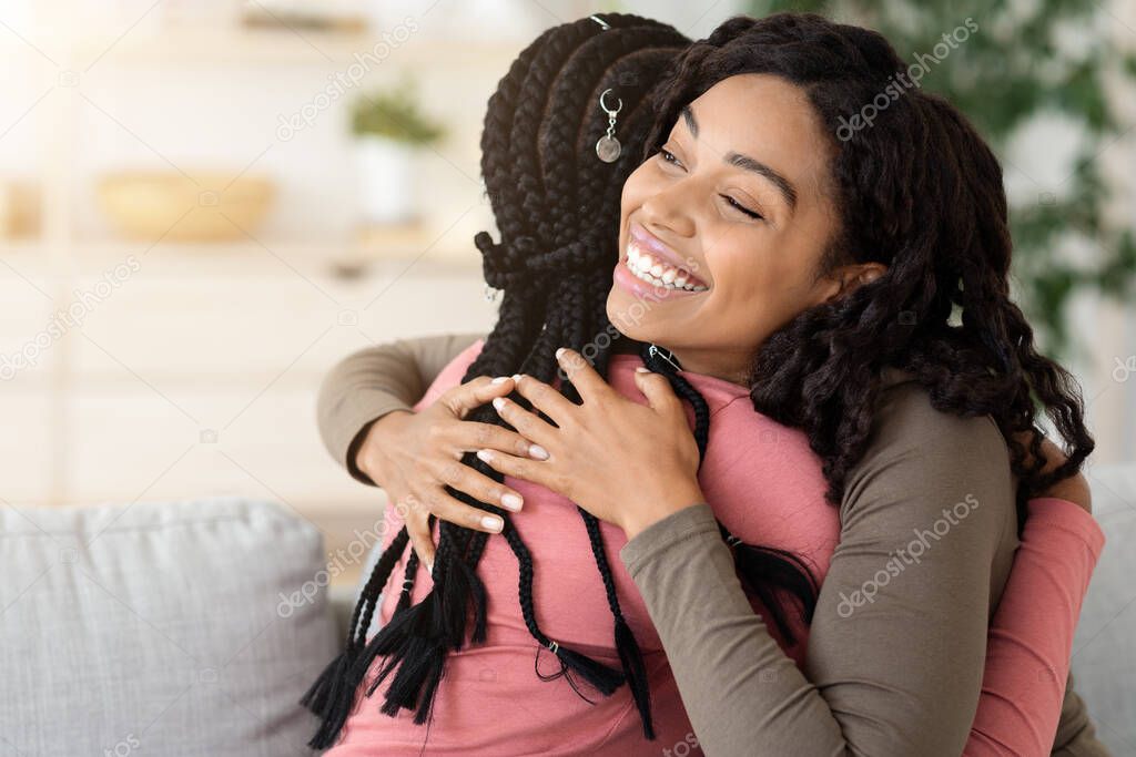Beautiful girl hugging her friend, home interior