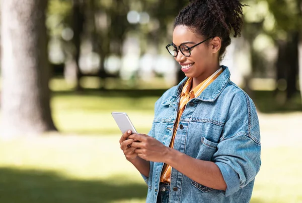 Happy Black Woman Holding Smartphone Reading Message Walking Outside