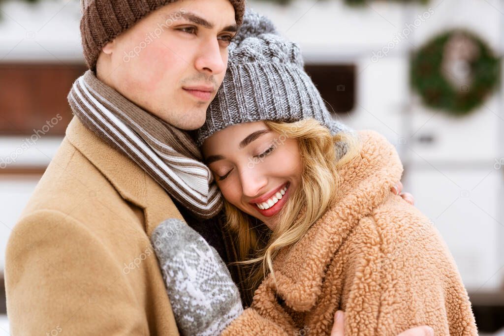 Young Affectionate Couple Enjoying Winter Day Together, Hugging And Bonding Outdoors