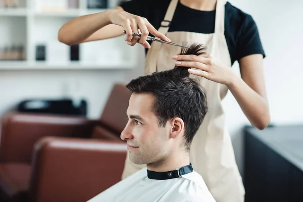 Young guy cutting hair at professional barber shop, free space — Stock Photo, Image