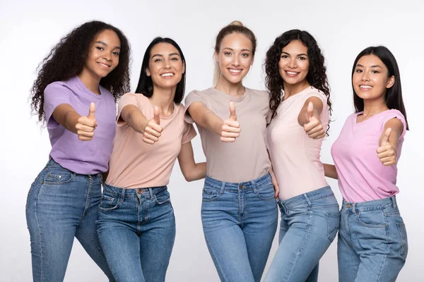Group Of Smiling Multiracial Ladies Gesturing Thumbs-Up Over White Background