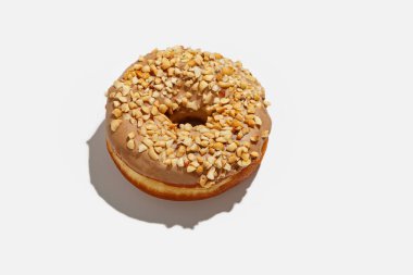 Zararlı tatlılar ve paket servis ya da covid-19 salgını sırasında evde sipariş. Lezzetli çörek ve beyaz arka planda gölgeli fındık.