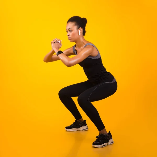 Afro Lady Exercising Doing Deep Squat Working Out, Studio Shot — стокове фото