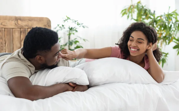 Happy beautiful black couple enjoying time together in bed — Stock Photo, Image