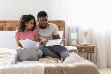 Afrikalı Amerikalı genç çift hafta sonu aile bütçesini kontrol ediyor.